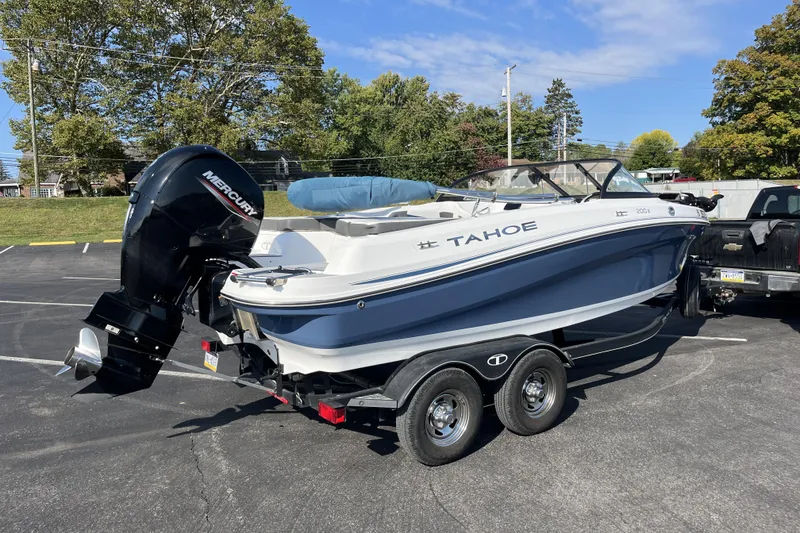 Slide: The Image of 2022 Tahoe 200 S boat on trailer with Mercury outboard motor in parking lot. - 3
