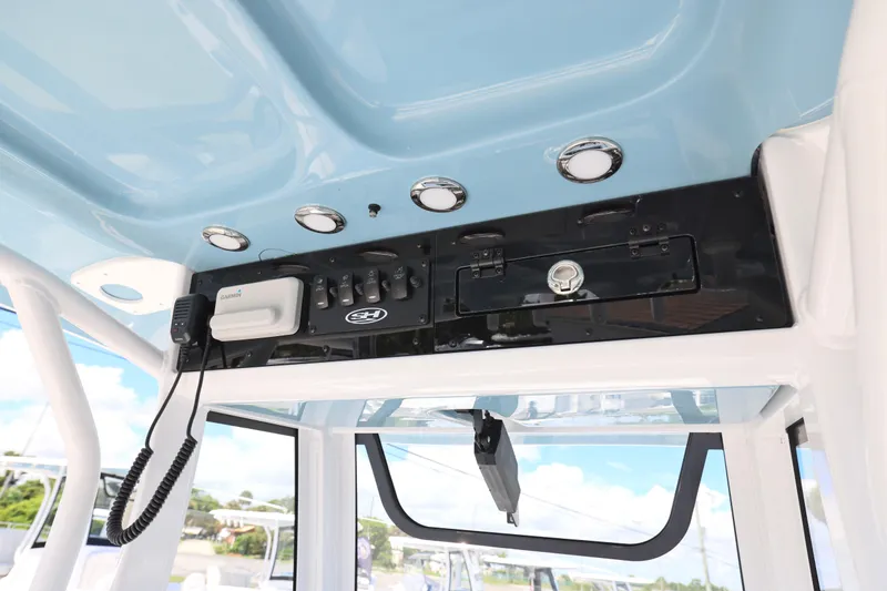 Slide: The Image of 2026 Sea Hunt Ultra 235 SE boat interior with rod holders and console. - 12