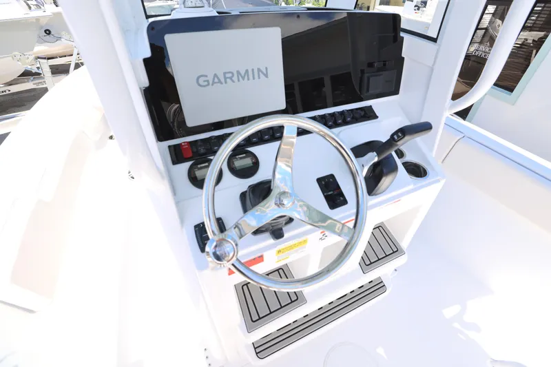 Slide: The Image of 2026 Sea Hunt Ultra 235 SE boat console with controls and Garmin device. - 14