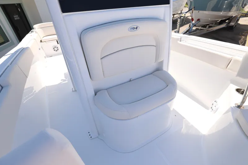 Slide: The Image of 2026 Sea Hunt Ultra 235 SE boat interior with seating and storage compartment. - 18