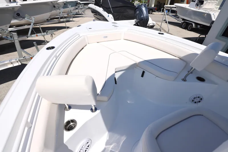 Slide: The Image of 2026 Sea Hunt Ultra 235 SE boat with sleek blue T-top under sunny sky. - 19