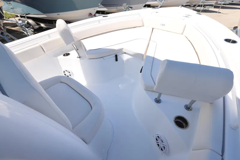 Slide: The Image of 2026 Sea Hunt Ultra 235 SE boat interior with white cushioned seating. - 20