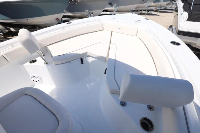 Slide: The Image of 2026 Sea Hunt Ultra 235 SE boat interior with white seating and cup holders. - 21