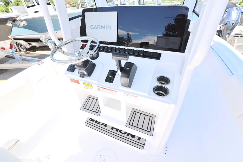 Slide: The Image of 2026 Sea Hunt Ultra 235 SE boat interior with cushioned seating and modern design. - 5