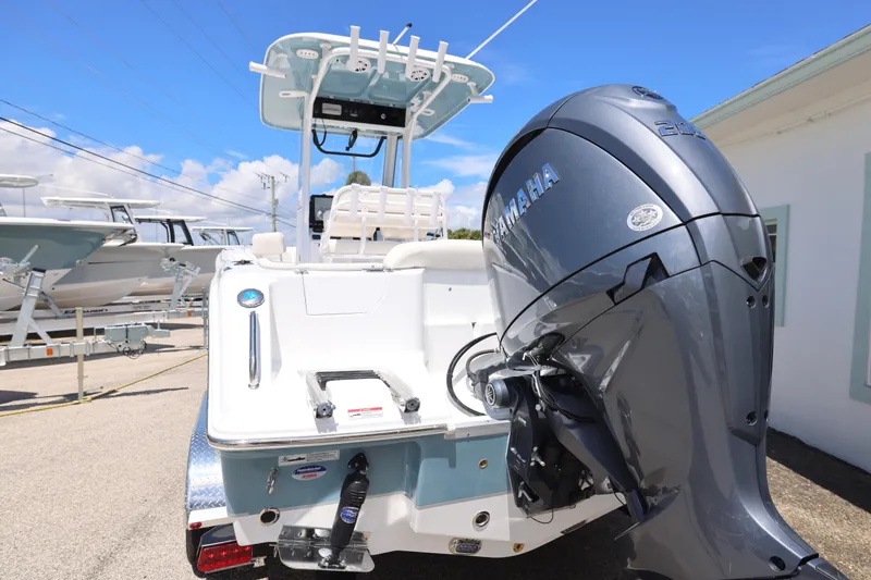 Slide: The Image of 2026 Sea Hunt Ultra 235 SE boat console with Garmin navigation system and steering wheel. - 7