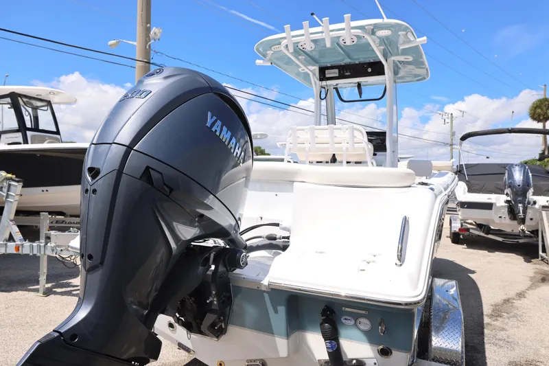 Slide: The Image of 2026 Sea Hunt Ultra 235 SE boat on trailer, parked outdoors under clear blue sky. - 8