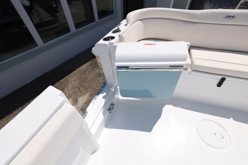 Slide: The Image of 2026 Sea Hunt Ultra 235 SE boat with Yamaha outboard motor, parked outdoors. - 9