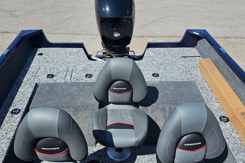 Slide: The Image of 2026 Bass Tracker PGV 175 boat interior with three gray seats and motor. - 16