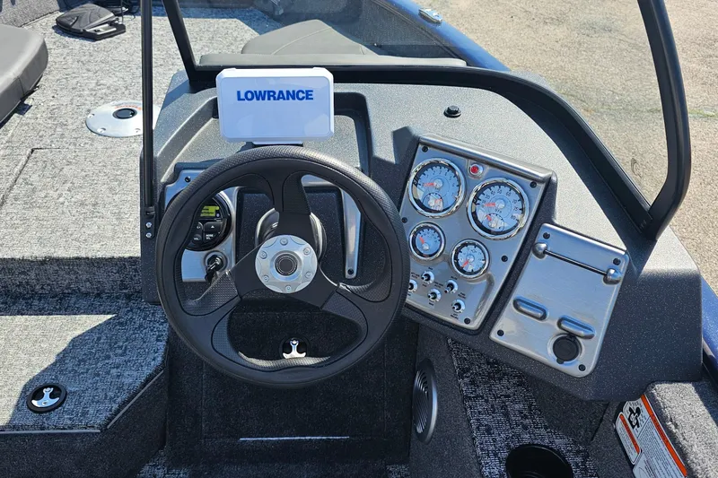Slide: The Image of 2026 Bass Tracker PGV 175 boat dashboard with steering wheel and Lowrance display. - 17