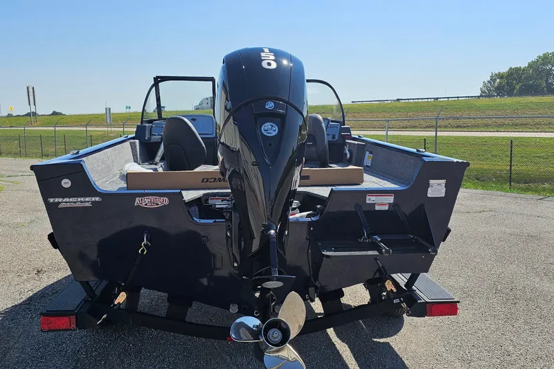 Slide: The Image of 2026 Bass Tracker PGV 175 boat with powerful outboard motor, parked on a trailer. - 3