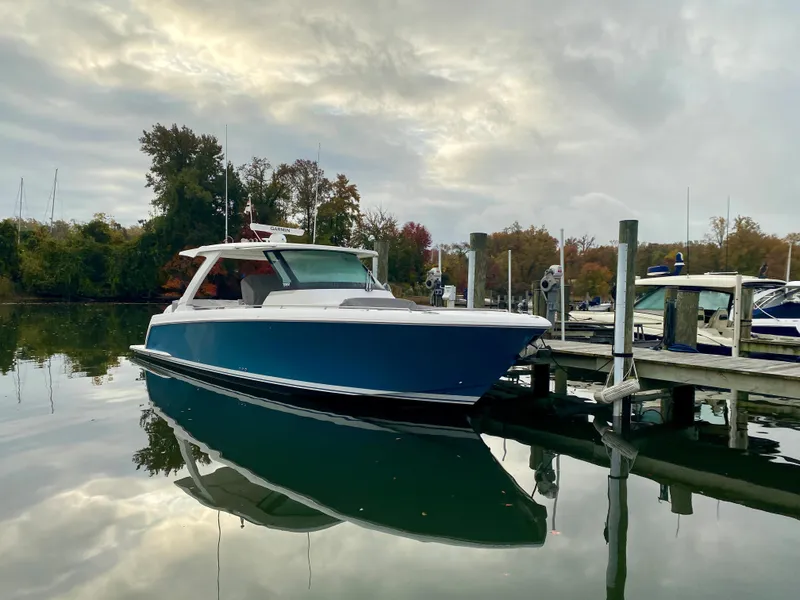 Slide: The Image of 2022 Tiara Yachts 38 LS docked on calm water under cloudy sky. - 2