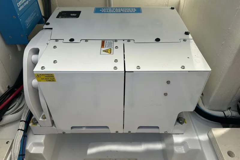 Slide: The Image of Electrical equipment inside a 2022 Tiara Yachts 38 LS, featuring safety warnings. - 21