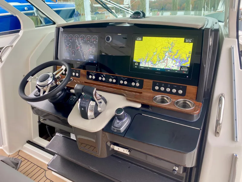 Slide: The Image of 2022 Tiara Yachts 38 LS helm with navigation screens and controls. - 6