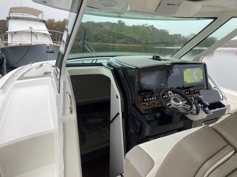 Slide: The Image of 2022 Tiara Yachts 38 LS helm with advanced navigation system and luxurious interior. - 7