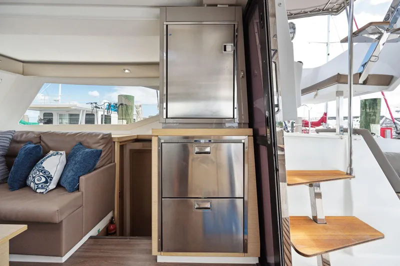 Slide: The Image of Interior of 2018 Fountaine Pajot Lucia 40 catamaran with modern kitchen and seating area. - 16