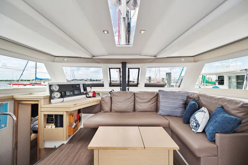 Slide: The Image of Interior of 2018 Fountaine Pajot Lucia 40 catamaran with modern seating and navigation area. - 3