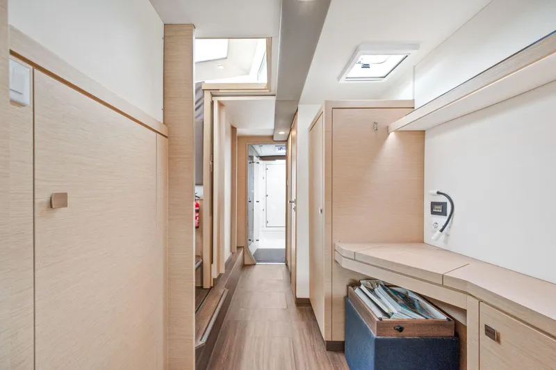 Slide: The Image of Interior of 2018 Fountaine Pajot Lucia 40 catamaran, featuring modern wood finishes and ample storage. - 31