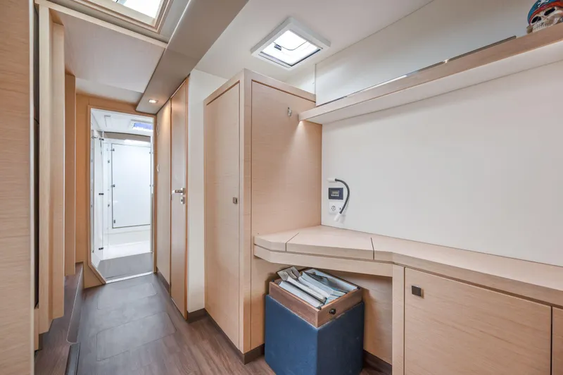 Slide: The Image of Interior of 2018 Fountaine Pajot Lucia 40 catamaran, featuring modern wood finish and ample storage. - 32