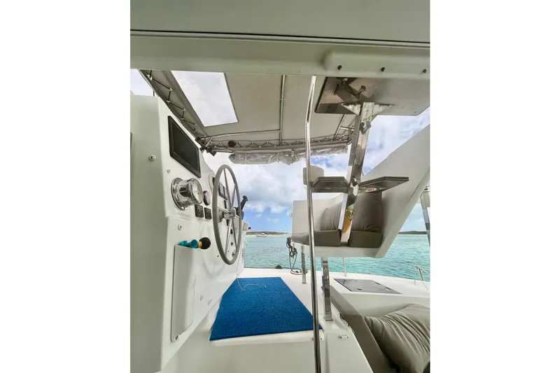 Slide: The Image of 2018 Fountaine Pajot Lucia 40 yacht helm with ocean view and modern controls. - 56