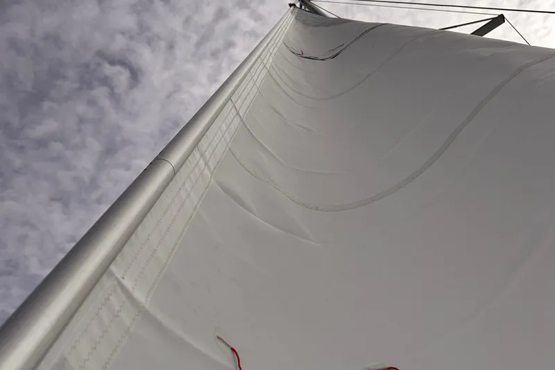 Slide: The Image of Close-up of a 2018 Fountaine Pajot Lucia 40 sail against a cloudy sky. - 66