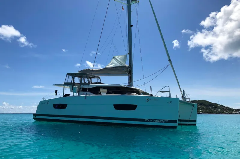Slide: The Image of 2018 Fountaine Pajot Lucia 40 catamaran sailing on clear turquoise waters. - 92