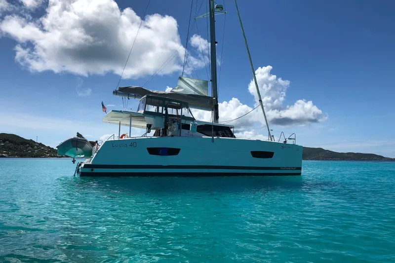 Slide: The Image of 2018 Fountaine Pajot Lucia 40 catamaran sailing on clear turquoise waters. - 93
