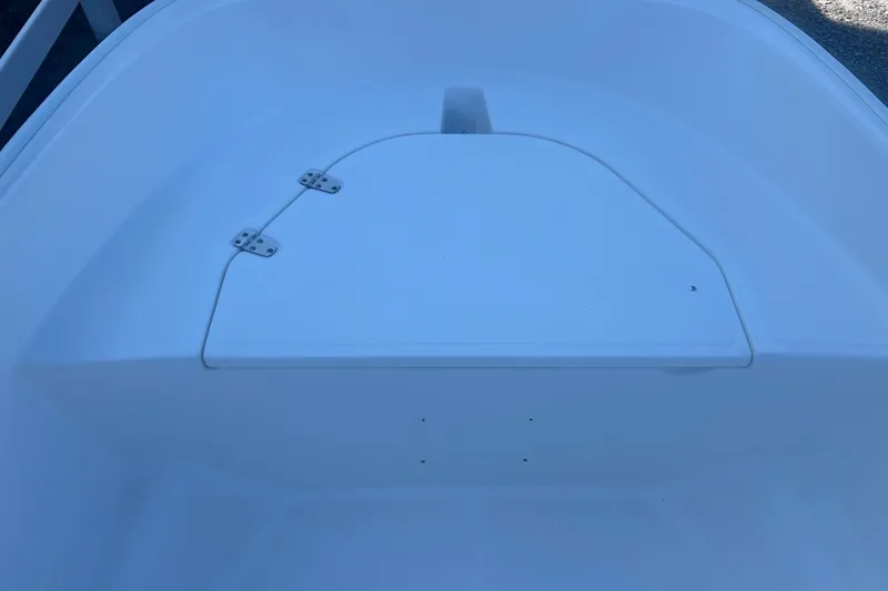 Slide: The Image of 2010 Boston Whaler 130 Super Sport interior with red fuel tank and railings. - 11