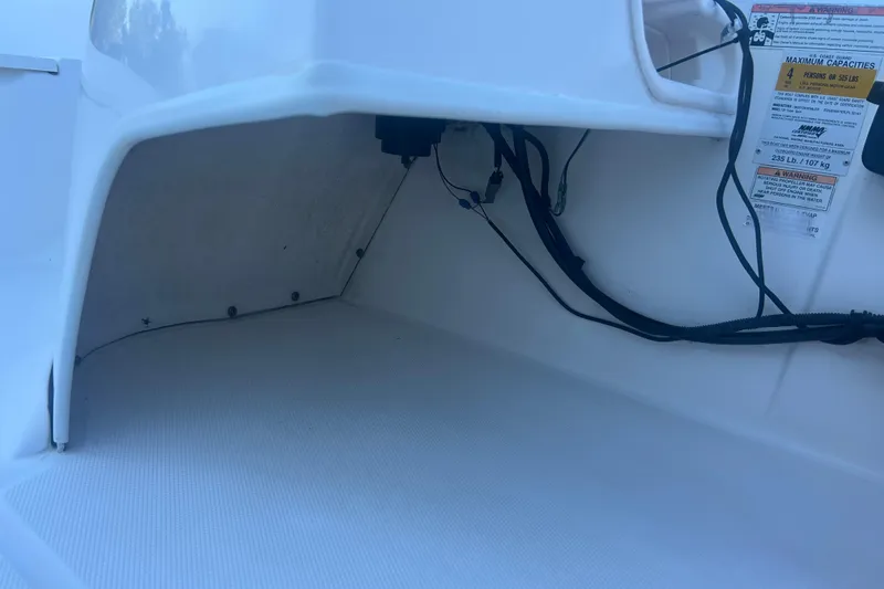 Slide: The Image of 2010 Boston Whaler 130 Super Sport boat, close-up view of logo and hull. - 13