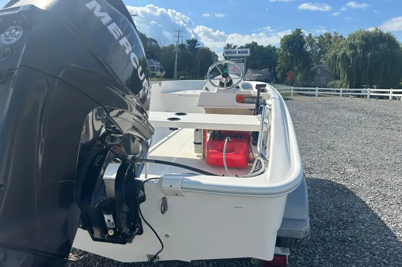 Slide: The Image of 2010 Boston Whaler 130 Super Sport boat on trailer, gravel background. - 18