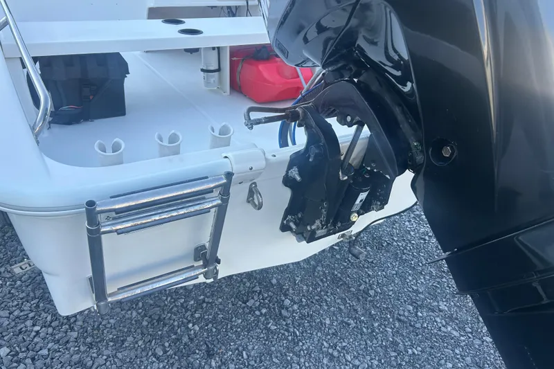 Slide: The Image of 2010 Boston Whaler 130 Super Sport boat on trailer, parked on gravel. - 3