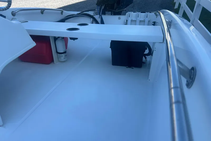 Slide: The Image of Interior view of a 2010 Boston Whaler 130 Super Sport boat, showing rod holders and wiring. - 7