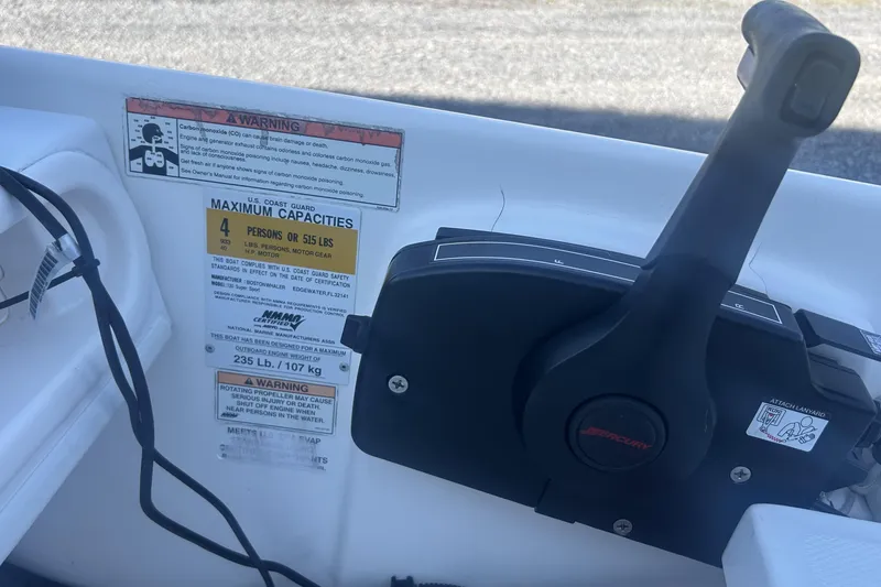 Slide: The Image of 2010 Boston Whaler 130 Super Sport boat dashboard with steering wheel and gauges. - 9