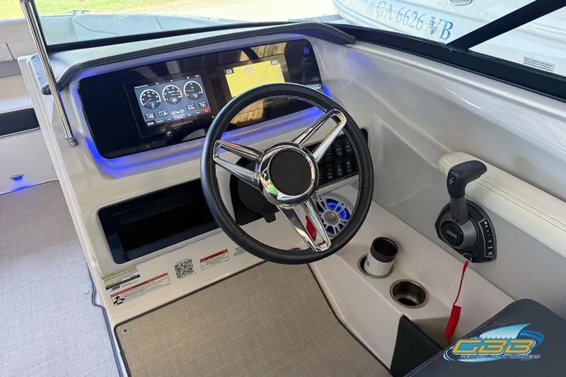 Slide: The Image of 2022 Regal LS2 Surf boat dashboard with steering wheel and digital display. - 13