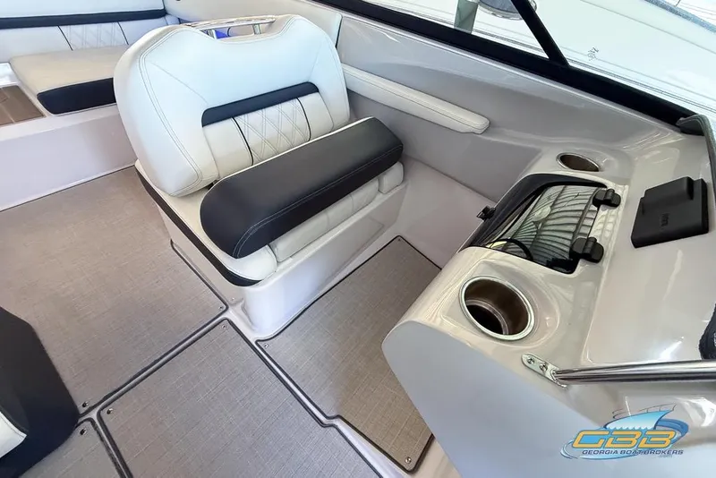 Slide: The Image of 2022 Regal LS2 Surf boat interior with cushioned seating and cup holders. - 15