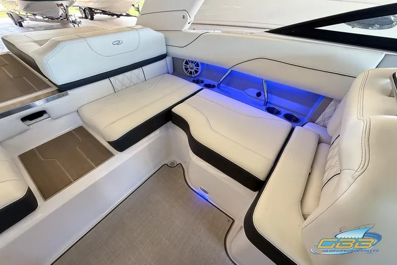 Slide: The Image of Luxurious interior of 2022 Regal LS2 Surf boat with blue LED lighting and white seating. - 16