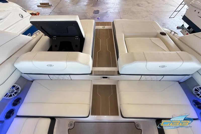 Slide: The Image of 2022 Regal LS2 Surf boat interior with white seating and wood accents. - 17