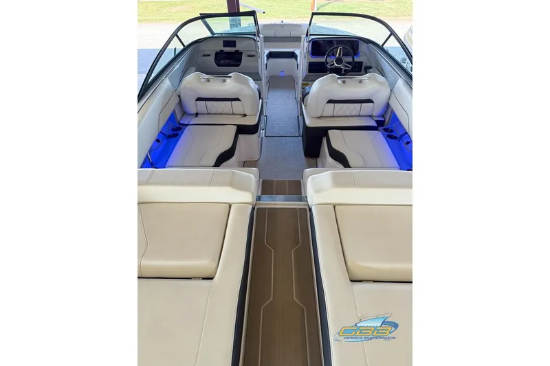 Slide: The Image of 2022 Regal LS2 Surf boat interior with luxurious seating and ambient blue lighting. - 20
