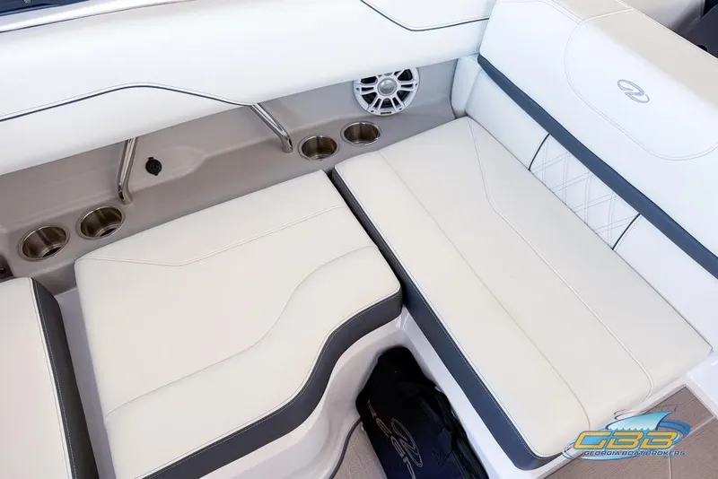 Slide: The Image of 2022 Regal LS2 Surf boat interior with white leather seating and cup holders. - 22