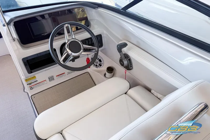 Slide: The Image of 2022 Regal LS2 Surf boat cockpit with steering wheel and controls. - 23
