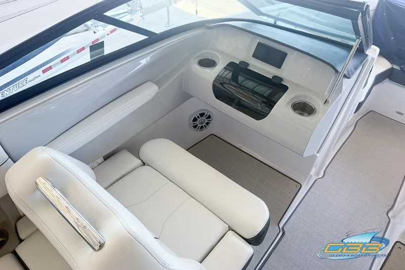 Slide: The Image of 2022 Regal LS2 Surf boat interior with white seating and modern dashboard design. - 24