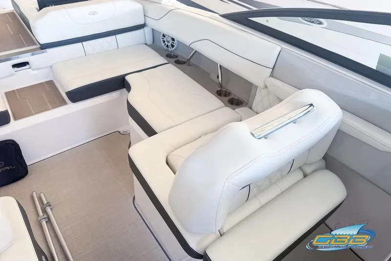 Slide: The Image of 2022 Regal LS2 Surf boat interior with white seating and cup holders. - 25
