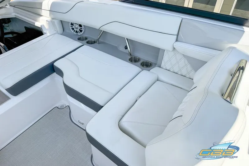 Slide: The Image of 2022 Regal LS2 Surf boat interior with white seating and cup holders. - 34
