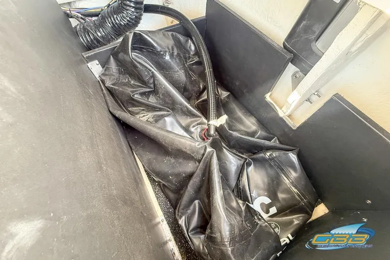 Slide: The Image of 2022 Regal LS2 Surf boat ballast system with black hose and compartment. - 46