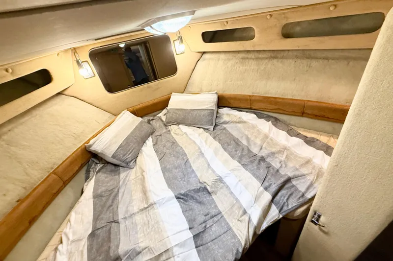 Slide: The Image of Cozy cabin interior of 1982 Chris-Craft 410 Motor Yacht with striped bedding. - 17