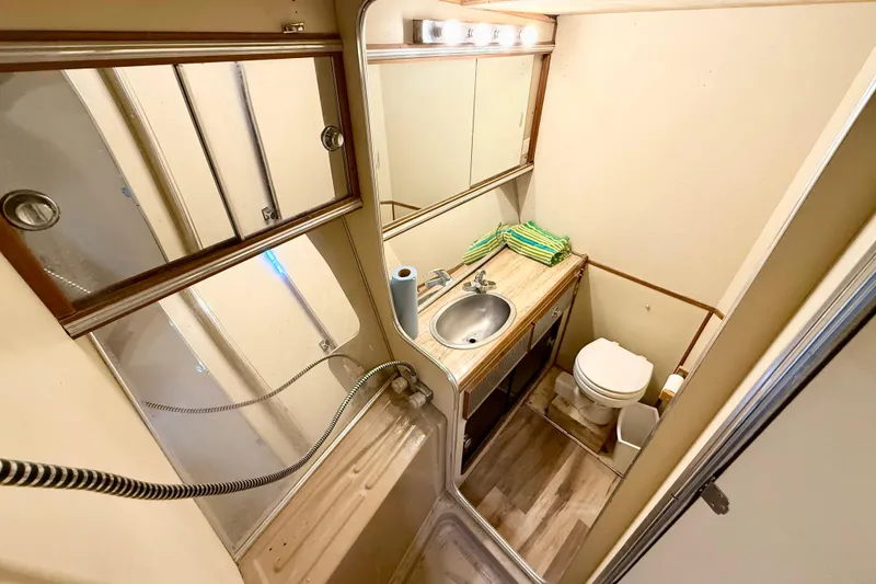 Slide: The Image of 1982 Chris-Craft 410 Motor Yacht bathroom with sink, toilet, and mirror. - 18