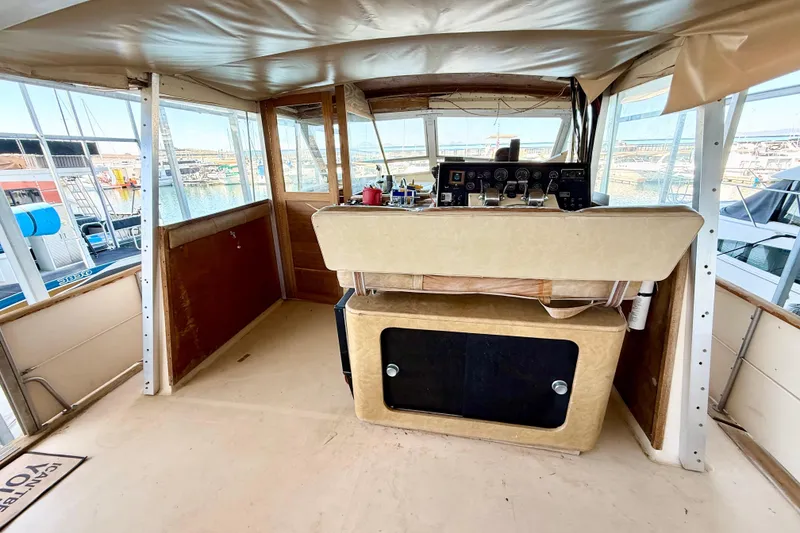 Slide: The Image of 1982 Chris-Craft 410 Motor Yacht helm with panoramic marina view. - 19