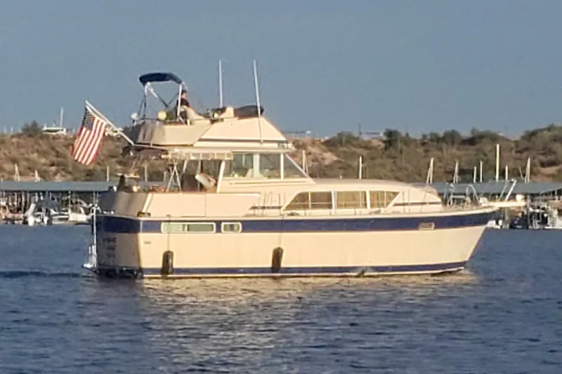 Slide: The Image of 1982 Chris-Craft 410 Motor Yacht cruising on a sunny day with American flag. - 5