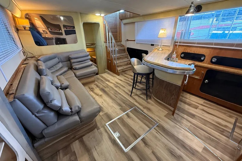 Slide: The Image of 1982 Chris-Craft 410 Motor Yacht interior with modern seating and bar area. - 6