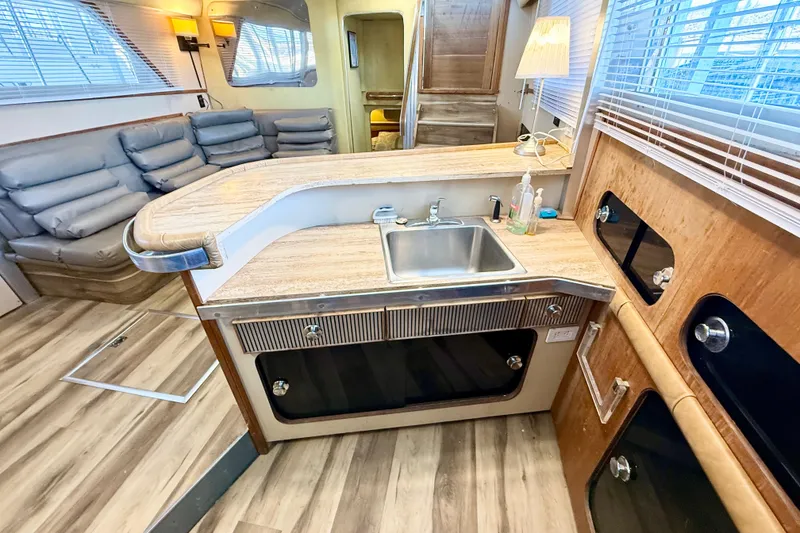 Slide: The Image of Interior of 1982 Chris-Craft 410 Motor Yacht with modern kitchen and seating area. - 9
