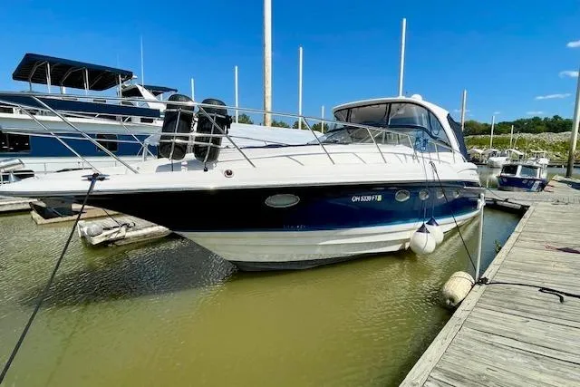 The Image of 2005 Regal Commodore 4260 yacht docked at marina under clear blue sky. - 1